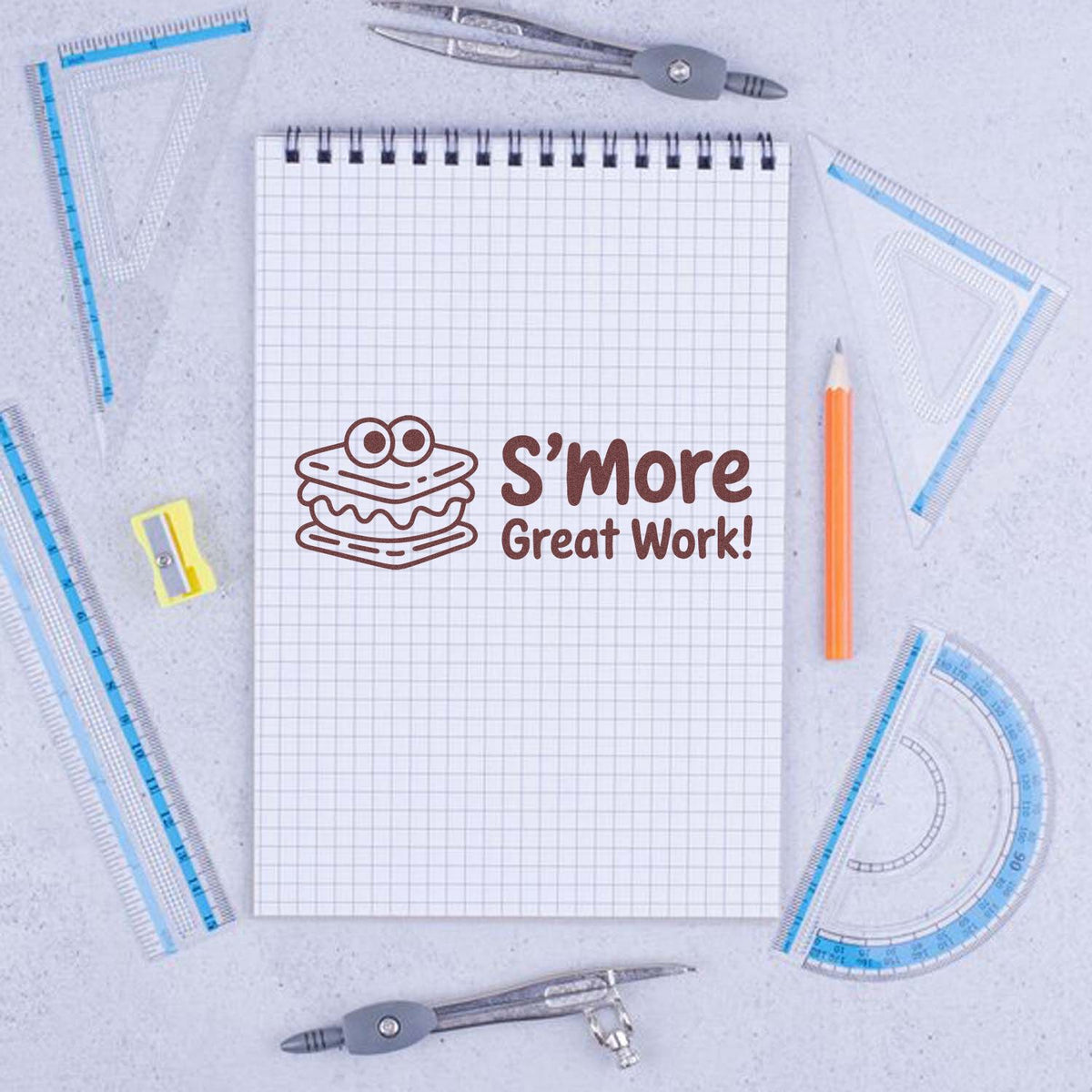 S'more Great Work rubber stamp on notebook with school supplies, ideal for teacher reward stamps and classroom incentive use.
