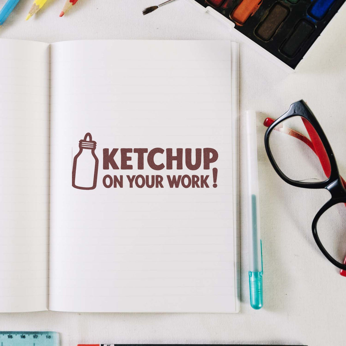 Ketchup on Your Work rubber stamp design on an open notebook, ideal for fun office, craft, and novelty stamp projects.