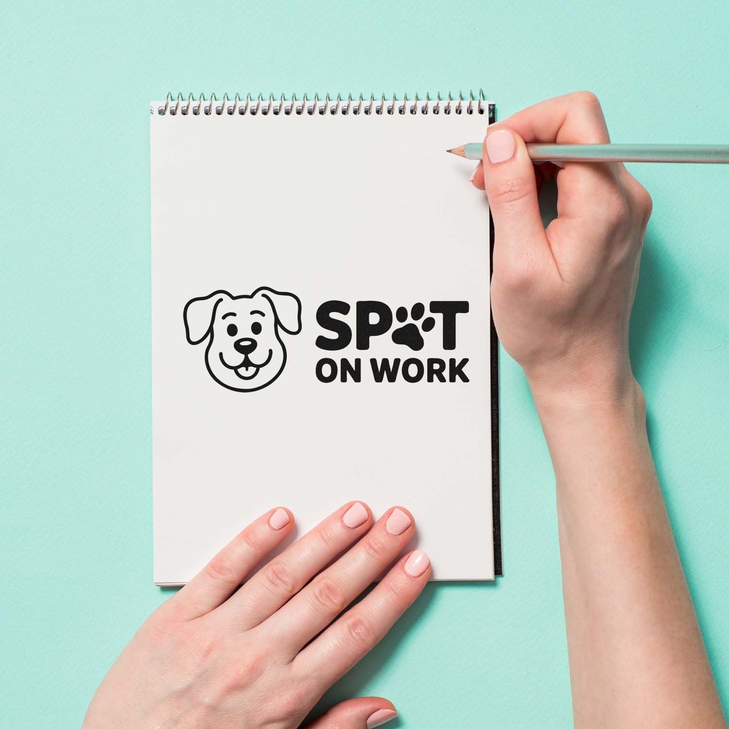 Custom rubber stamp with dog paw logo and Spot On Work imprint on notebook for pet business branding.