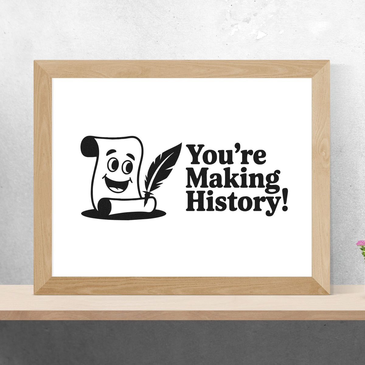 Rubber stamp design with scroll and quill reading Youre Making History! framed mockup for teachers and office use.