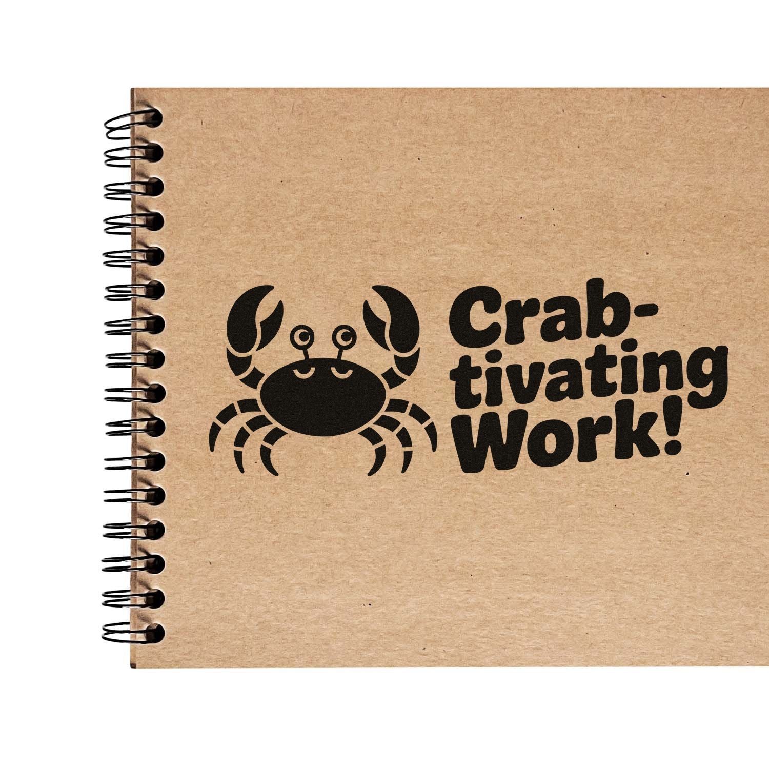 Crab rubber stamp design with Crab-tivating Work! on a kraft notebook, perfect for playful craft and stationery branding.