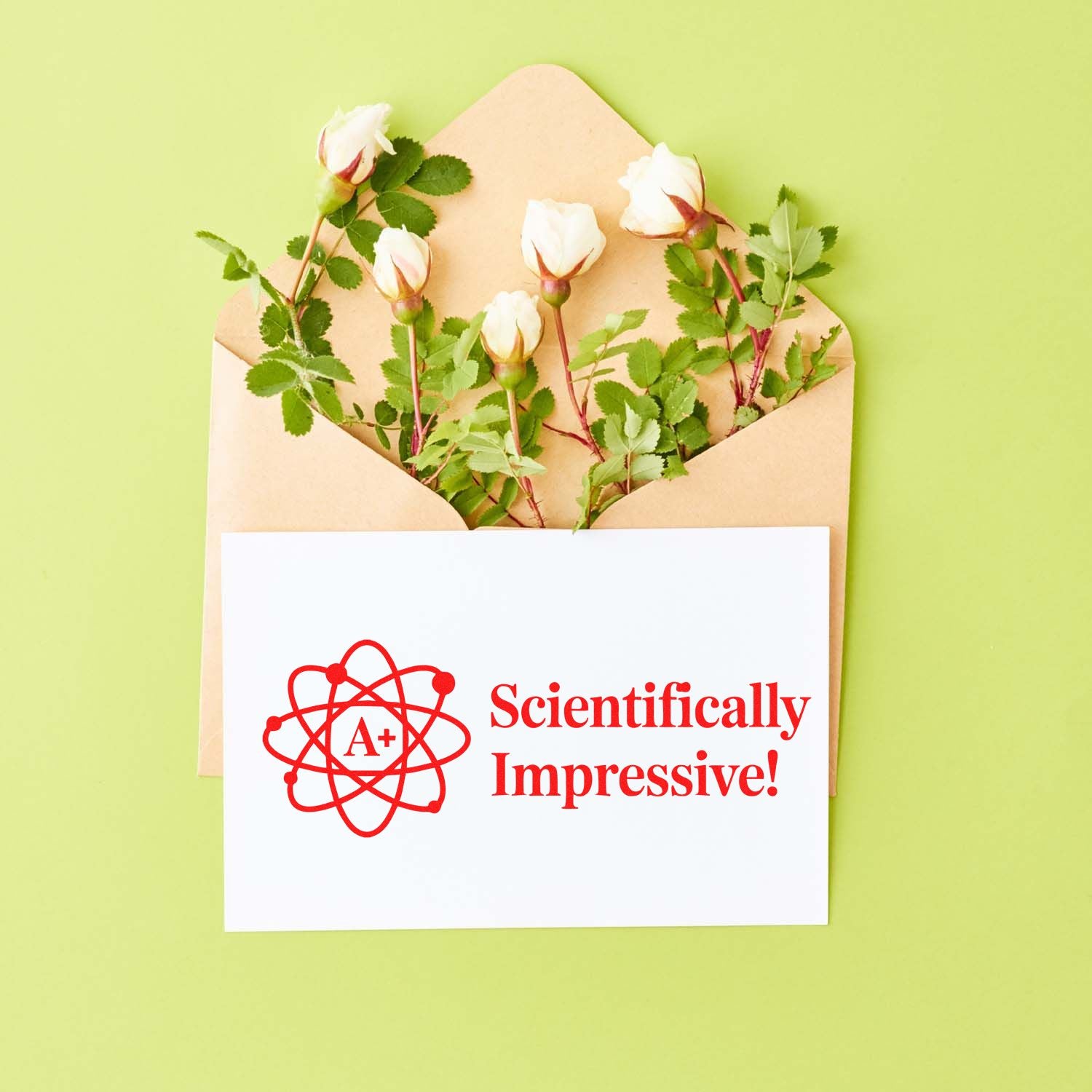 Scientifically impressive! A+ atom rubber stamp design on a card, shown in an envelope with flowers.