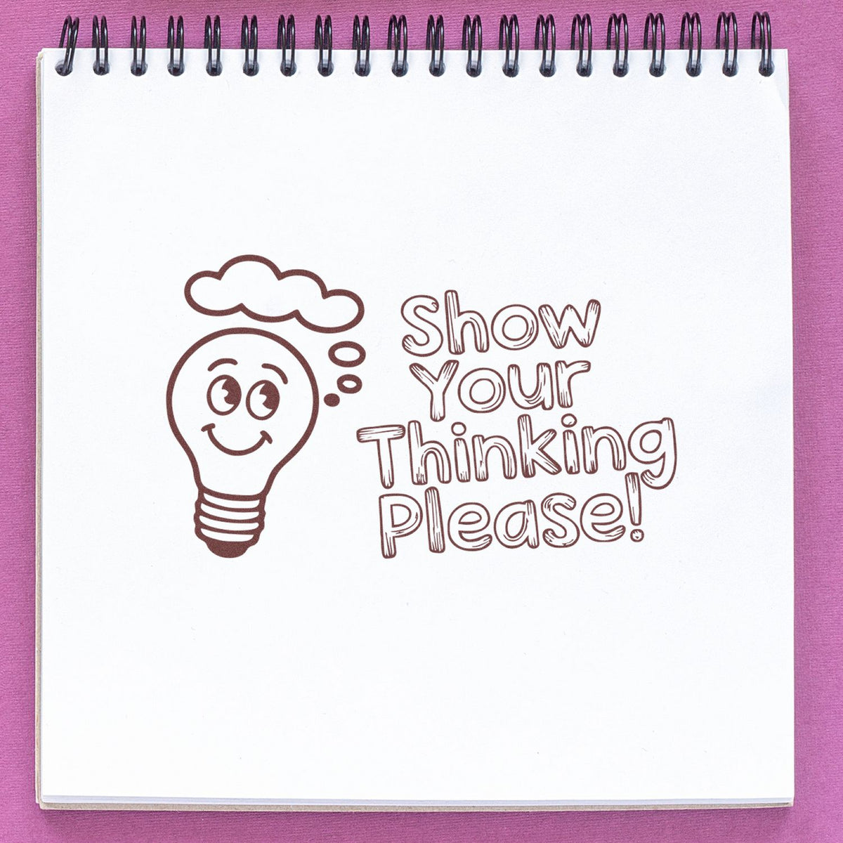 Rubber stamp design with a smiling lightbulb and the phrase Show Your Thinking Please! for classroom work.