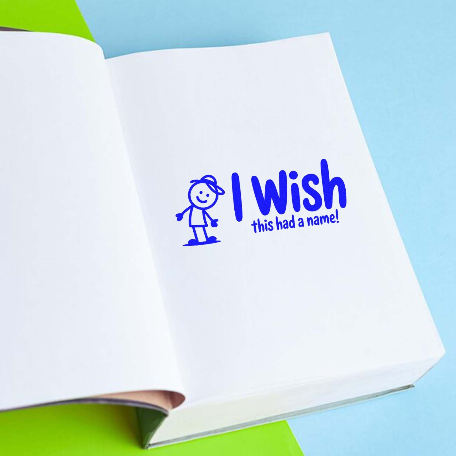 Blue rubber stamp design reading I wish this had a name! on a notebook page, ideal for playful personalized stationery.
