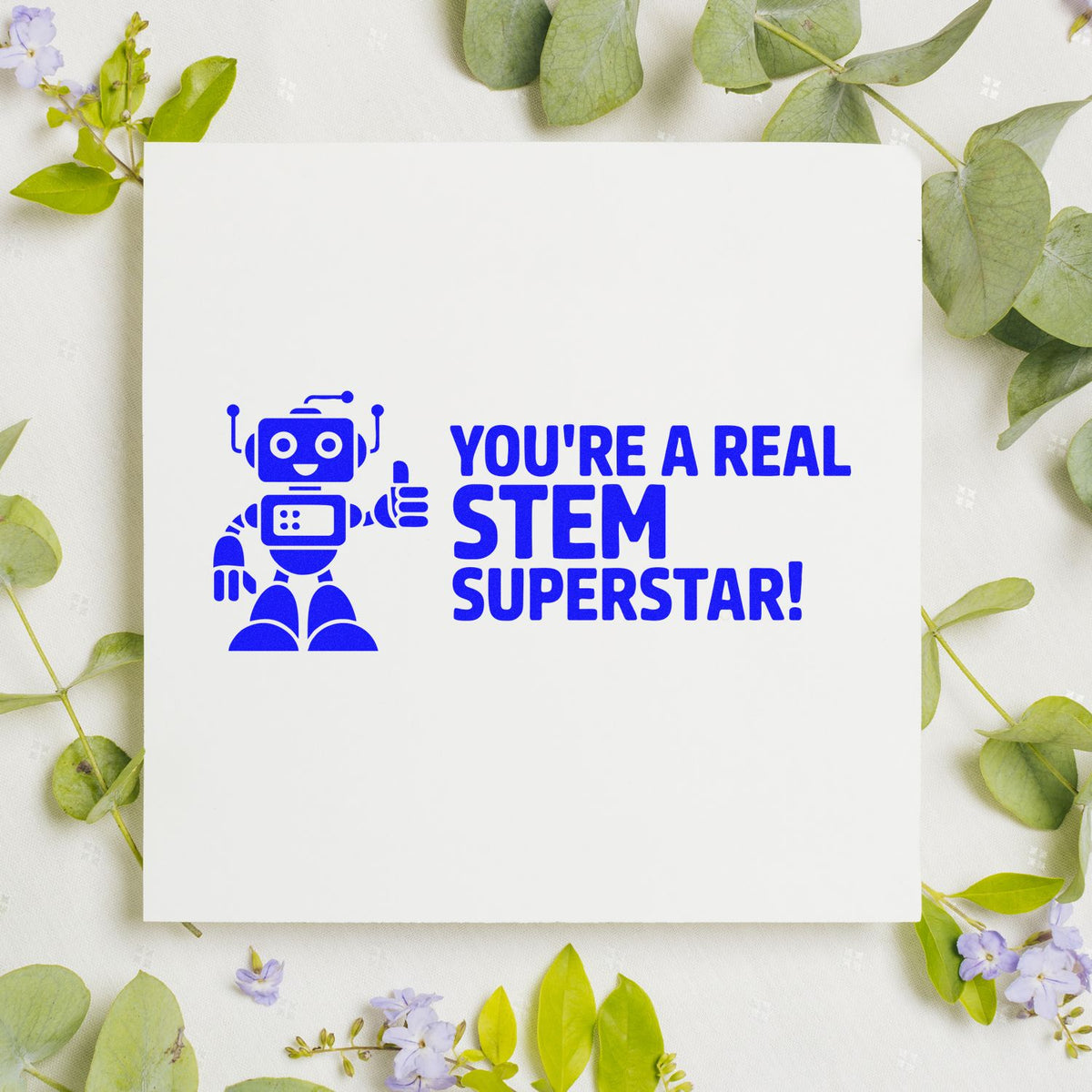 Blue STEM rubber stamp with robot and Youre a Real STEM Superstar! for teacher rewards and classroom encouragement.