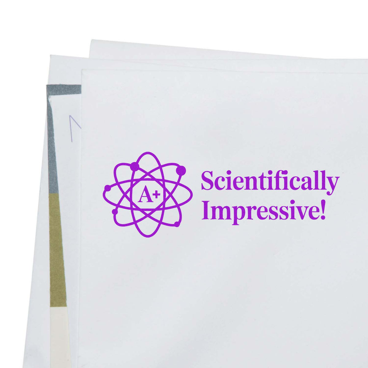 Purple Scientifically Impressive! A+ atom rubber stamp on paper, ideal for grading science work and classroom feedback.