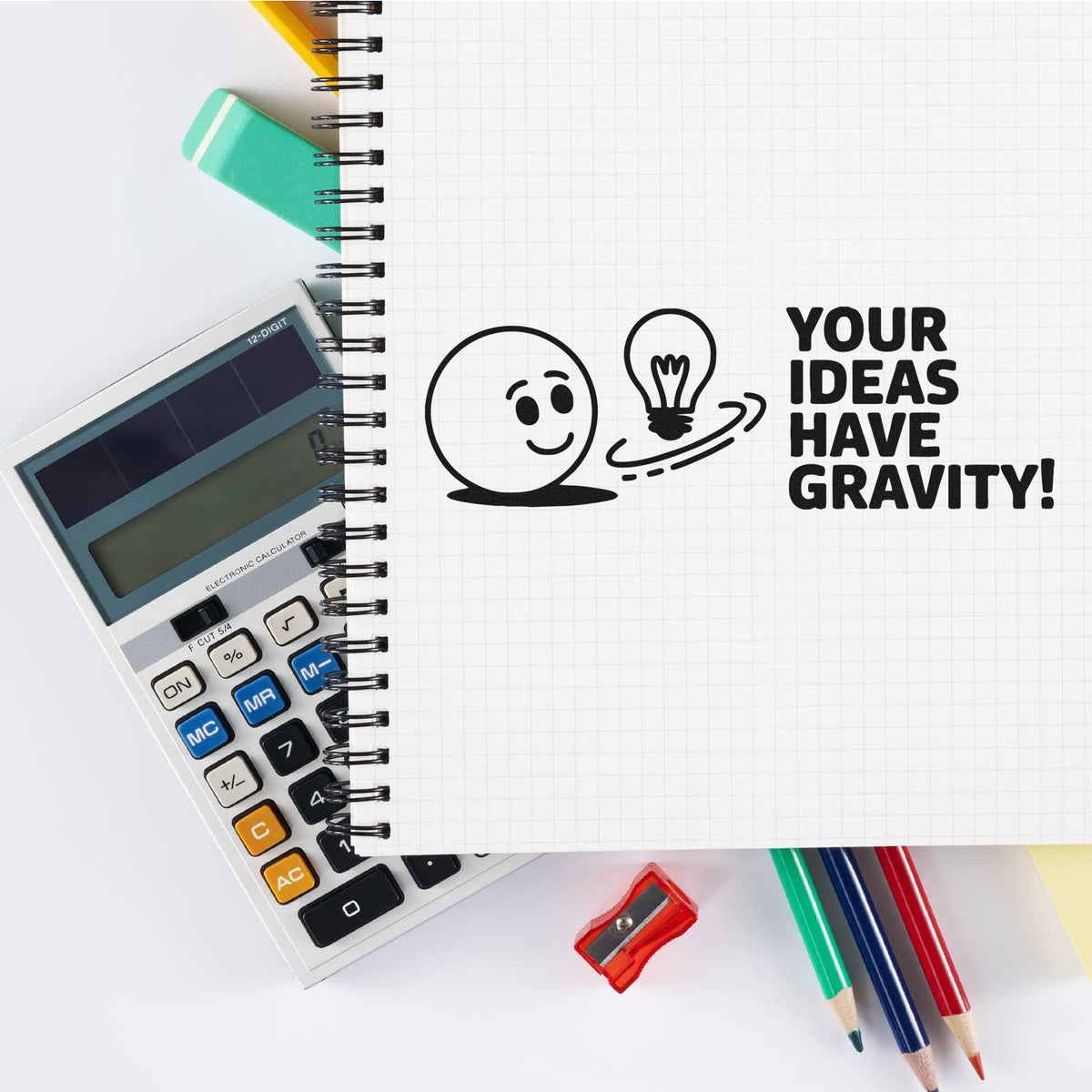Custom rubber stamp design reading Your ideas have gravity! for creative office, school, and stationery branding.