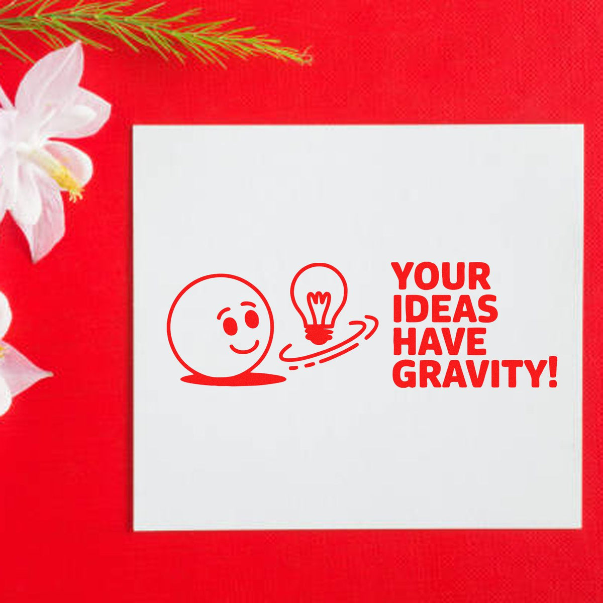 Custom rubber stamp design with smiling face, lightbulb icon, and Your Ideas Have Gravity! slogan.
