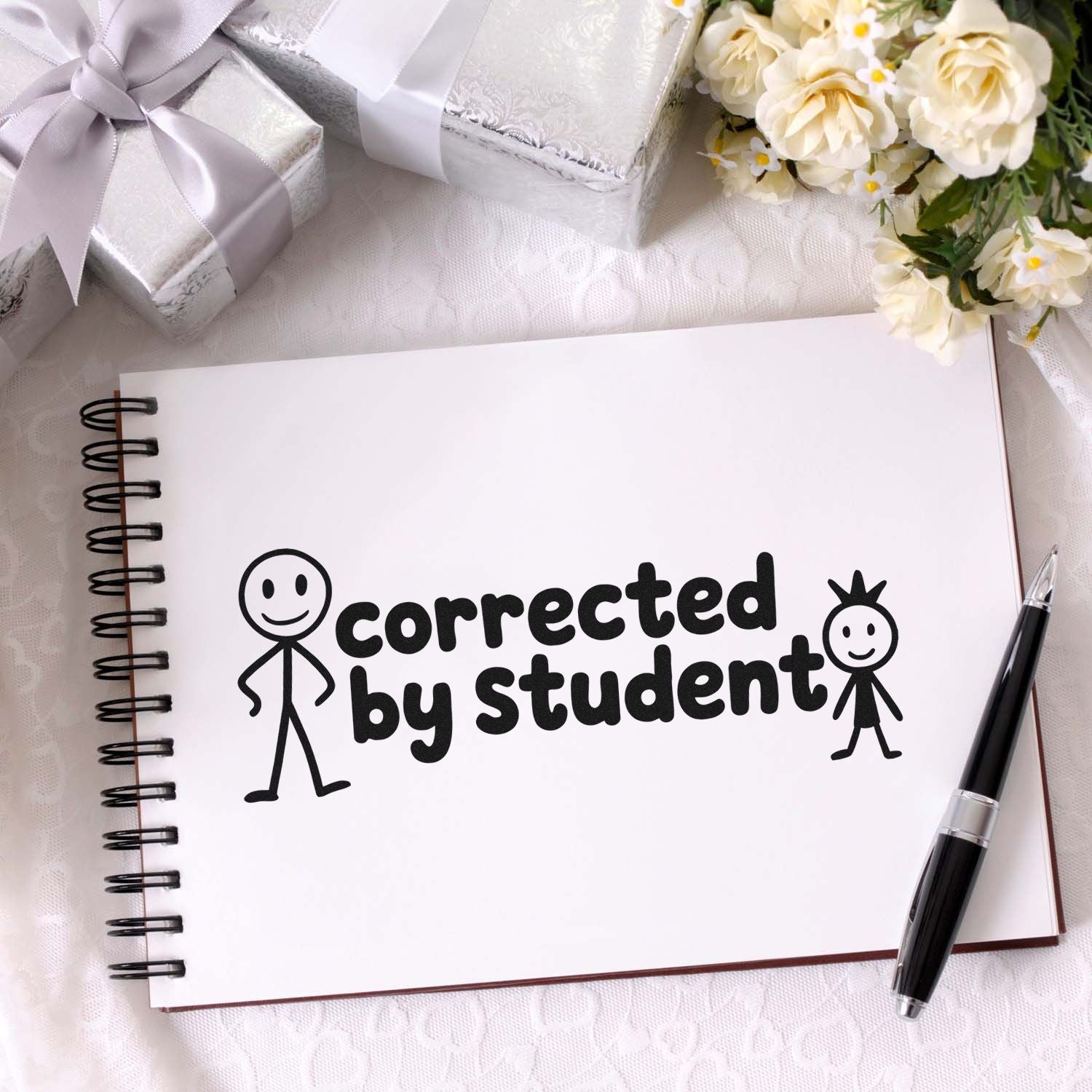 Corrected by Student rubber stamp design on notebook page, ideal for teacher grading and classroom feedback.