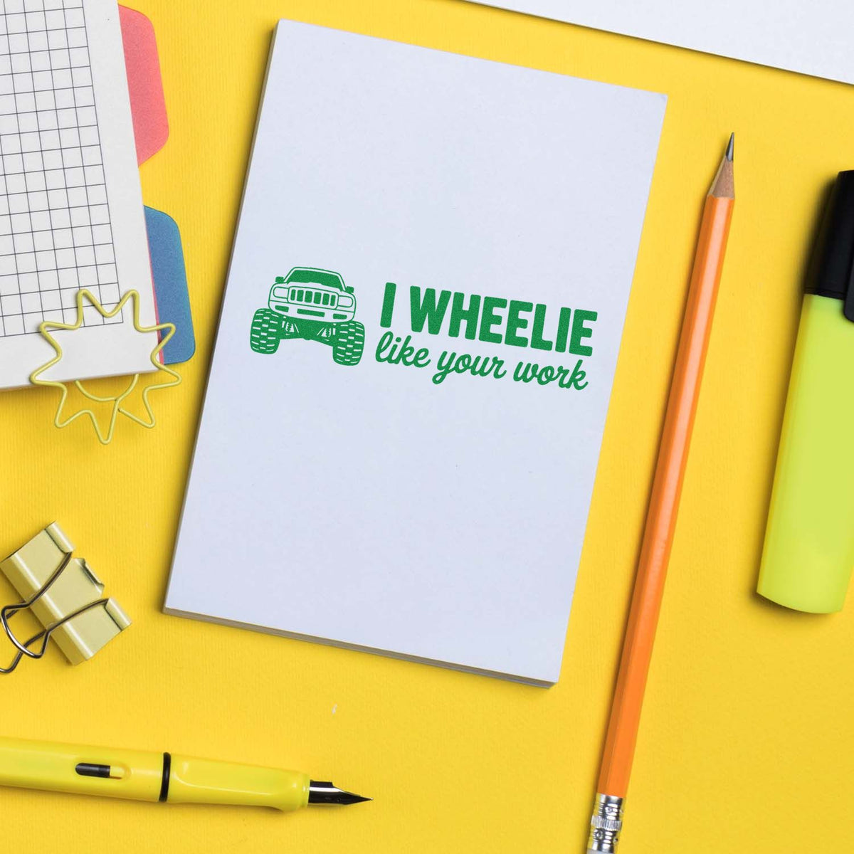 Monster truck rubber stamp reading I wheelie like your work on notebook, a fun custom stamp for teacher rewards and office notes.