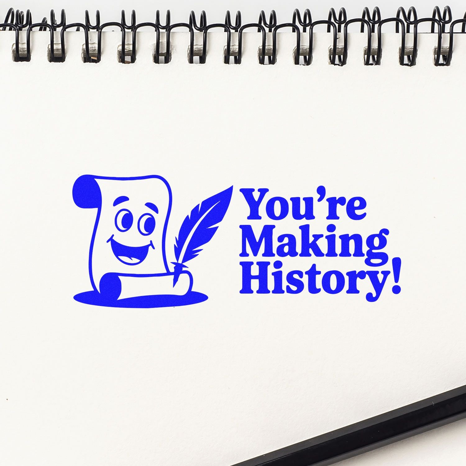 Blue rubber stamp impression reading Youre Making History! with scroll and quill design for inspirational custom stamps.