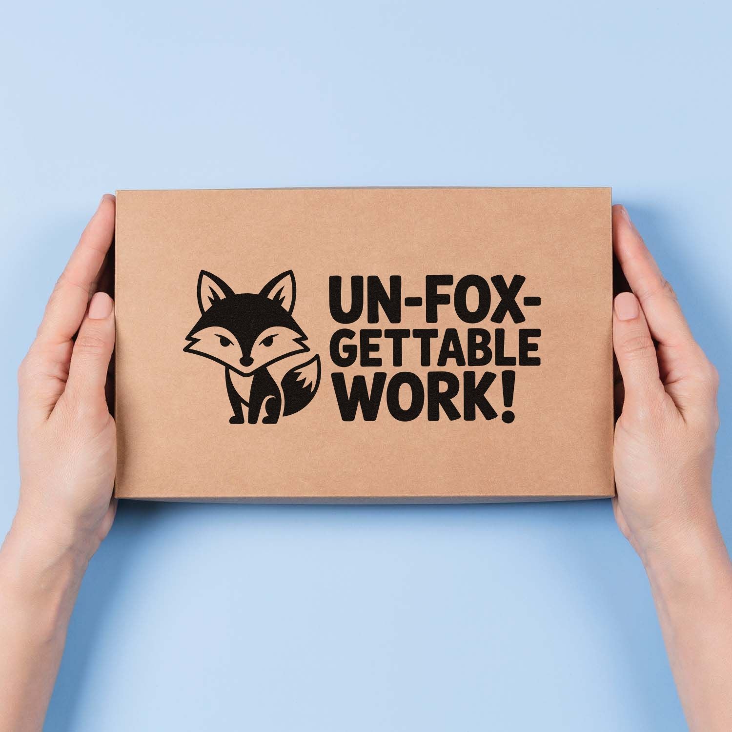 Custom rubber stamp fox logo with Un-fox-gettable Work! on kraft shipping box for branded packaging.