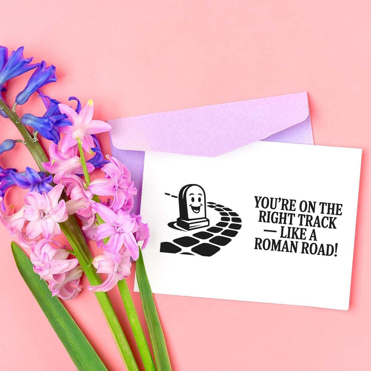 Funny Roman road rubber stamp design with Youre on the right track pun for history-themed handmade cards.