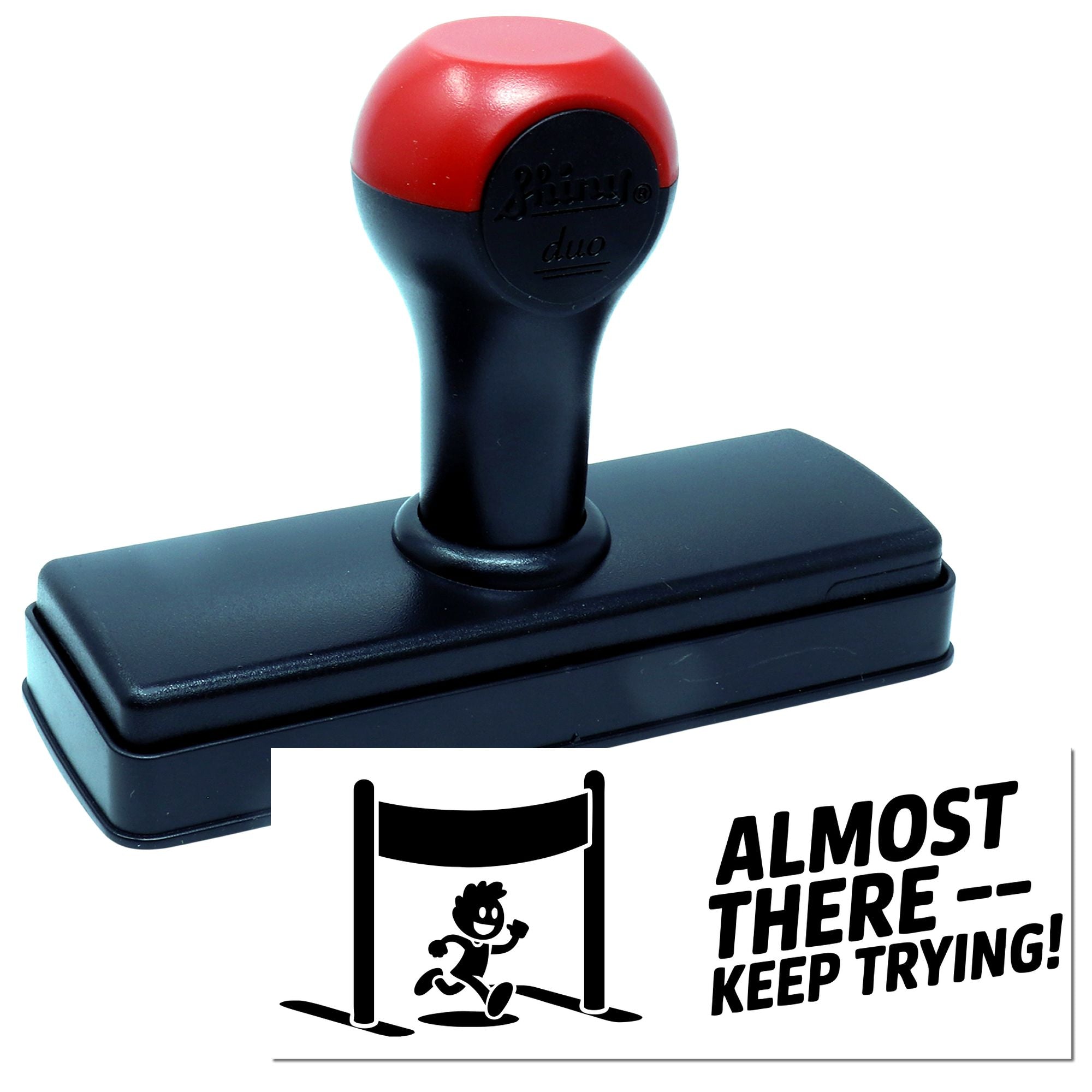Self-inking rubber stamp with Almost ThereKeep Trying! motivational design and runner hurdle icon.