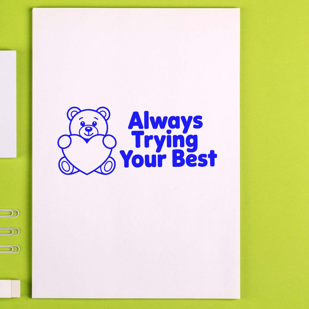 Motivational rubber stamp design with teddy bear and heart reading Always Trying Your Best for classroom rewards.