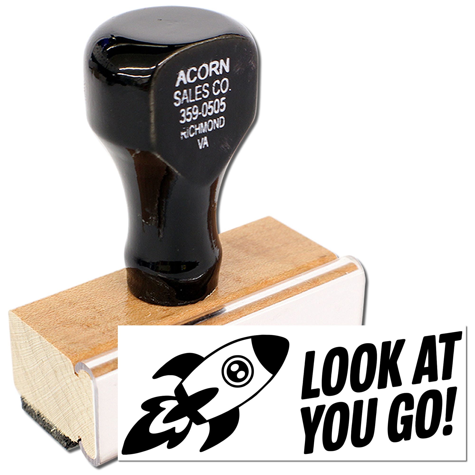 Custom wooden rubber stamp with rocket logo and Look at You Go! design for motivational cards and packaging.