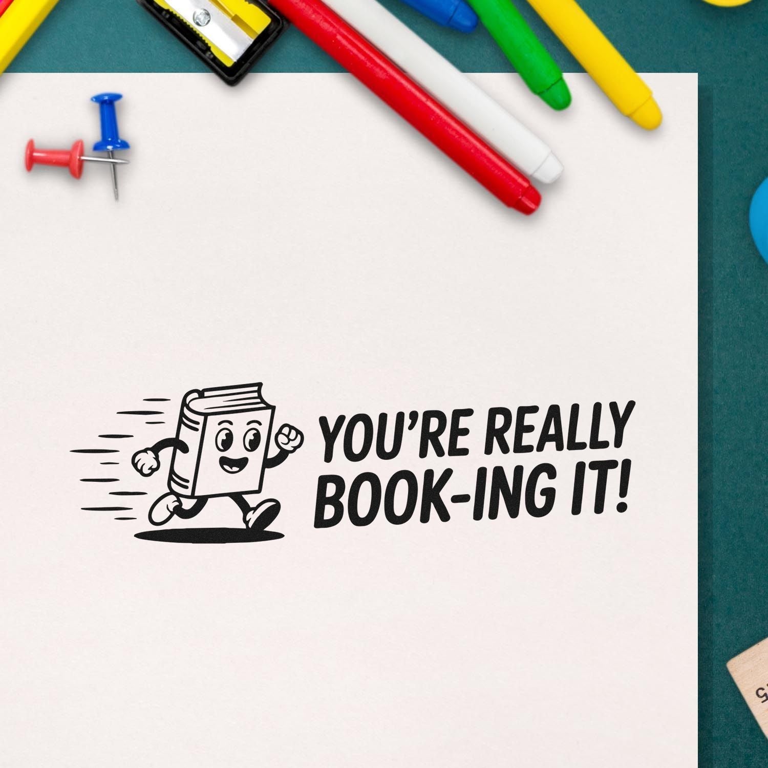 Rubber stamp design with running book graphic and Youre really book-ing it! text for school or library use.