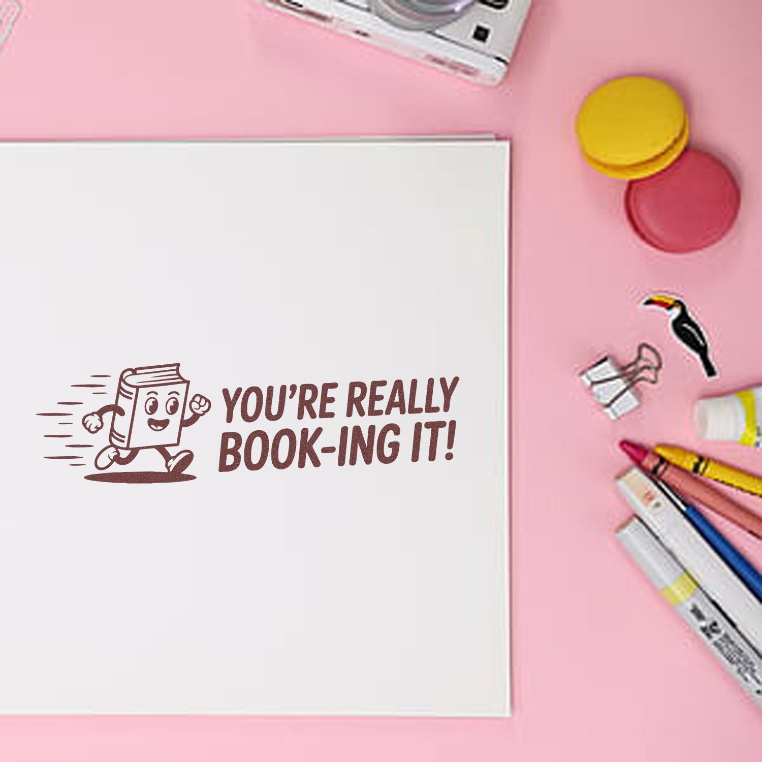 Book-themed rubber stamp reading Youre really book-ing it! for library, teacher, and reading rewards.