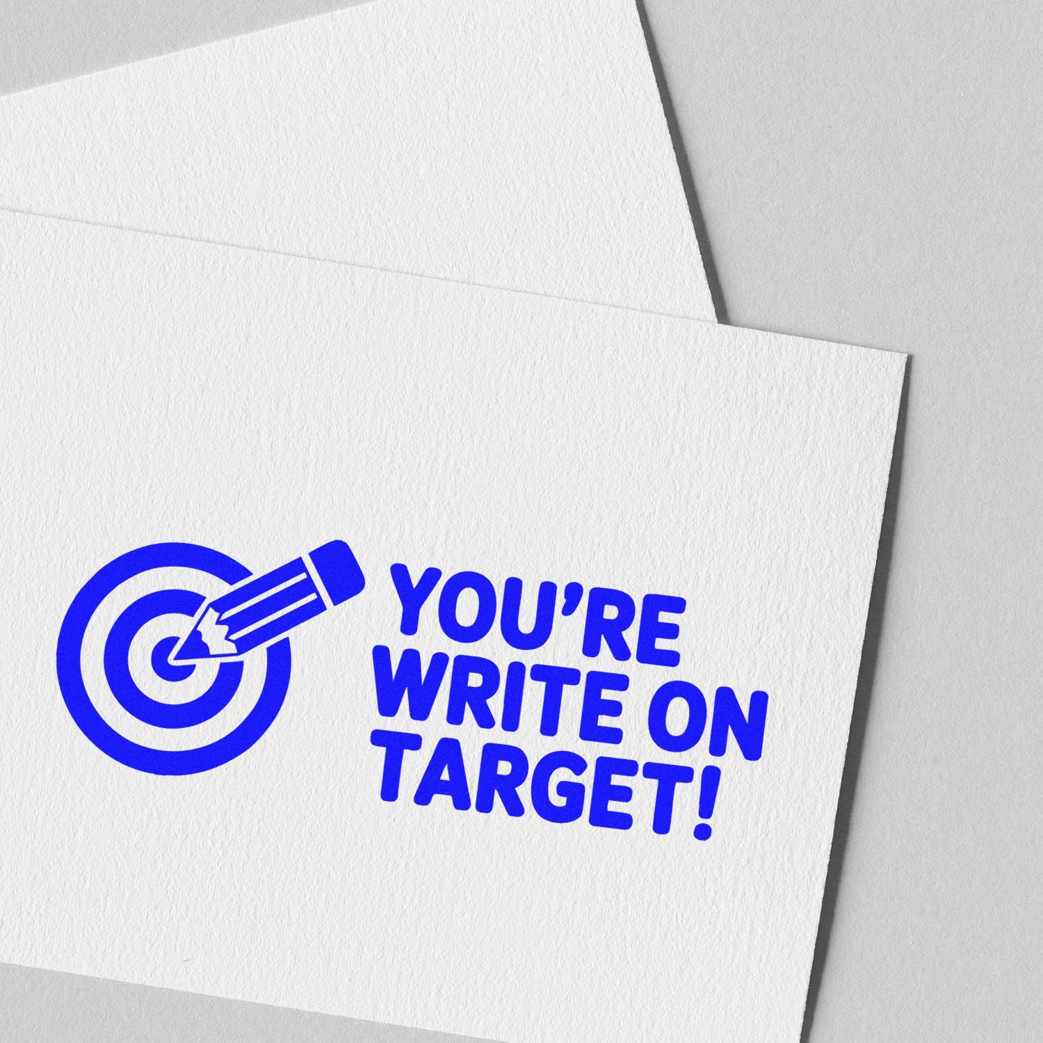 Custom rubber stamp design with target and pencil icon, reading Youre Write on Target on white paper.