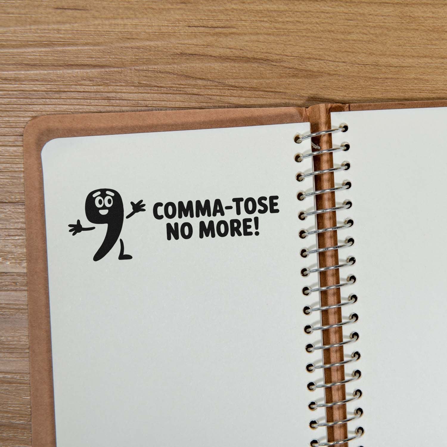 Funny rubber stamp reading Comma-tose No More! stamped in a notebook, ideal for grammar and teacher-themed stationery.