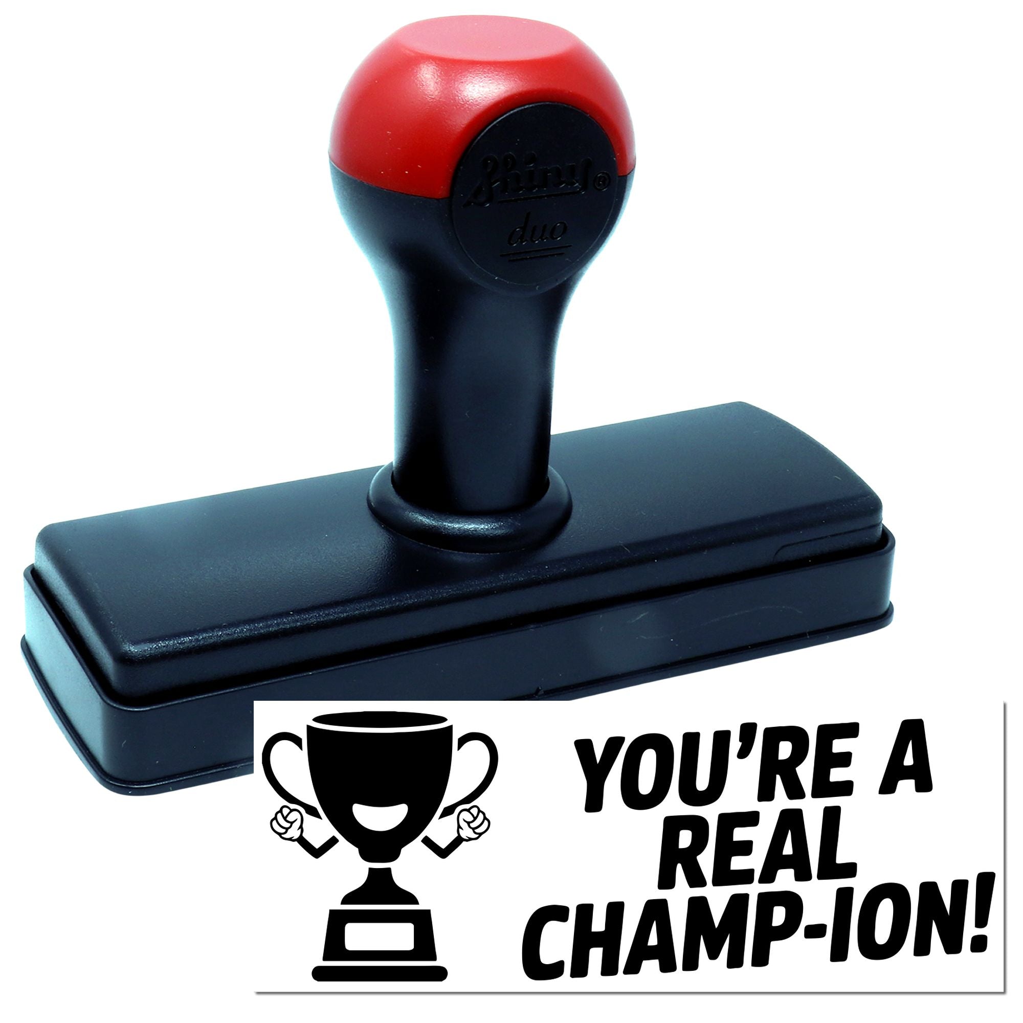 Self-inking rubber stamp with trophy design and Youre a Real Champ-ion! message for awards or motivational labeling.
