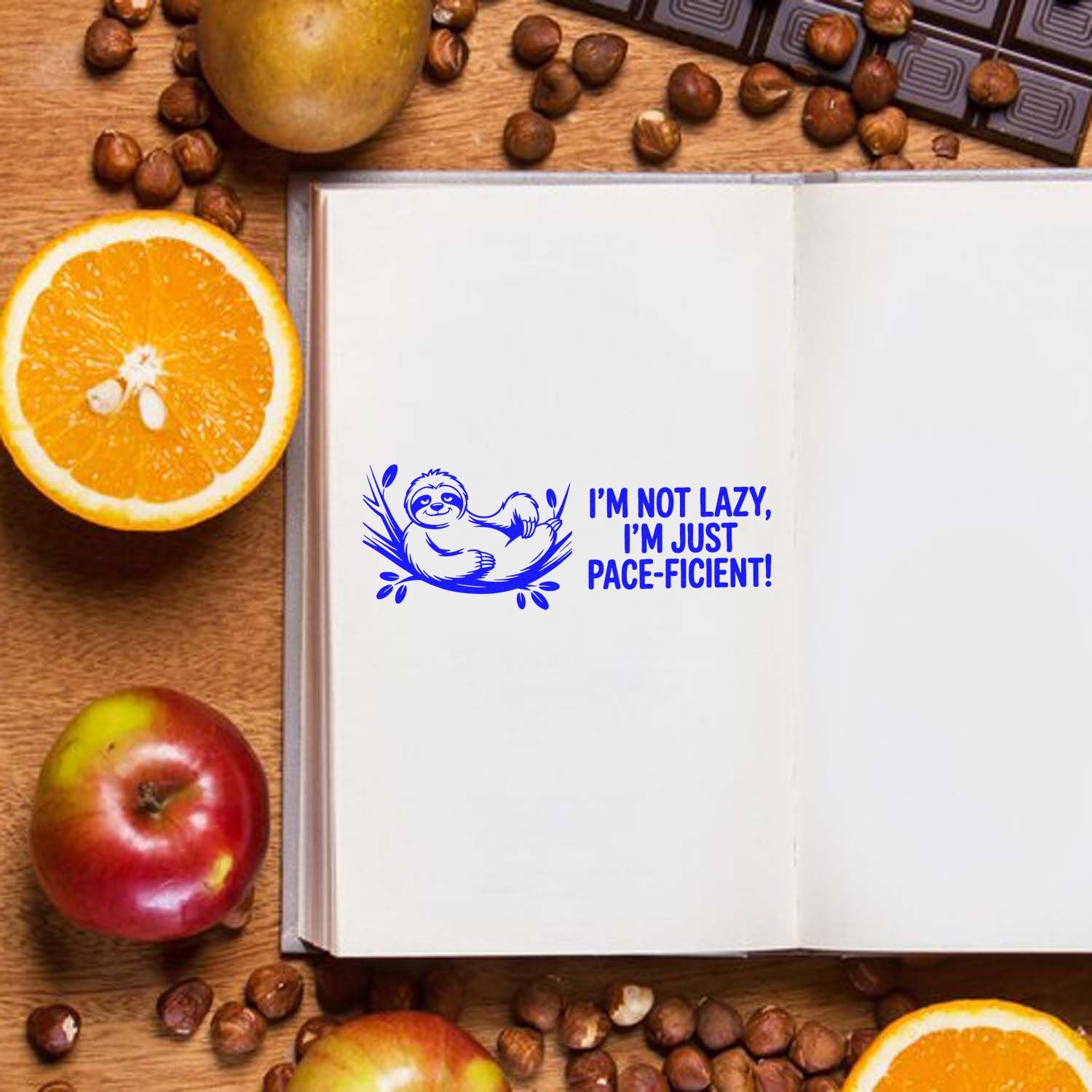 Funny sloth rubber stamp reading Im not lazy, Im just pace-ficient on an open journal for planners and craft projects.