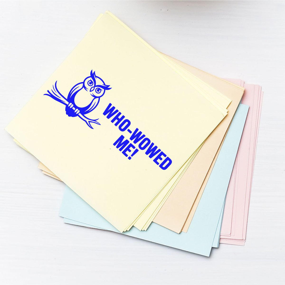 Blue owl Who-Wowed Me! rubber stamp on pastel paper stack for teacher or office feedback.