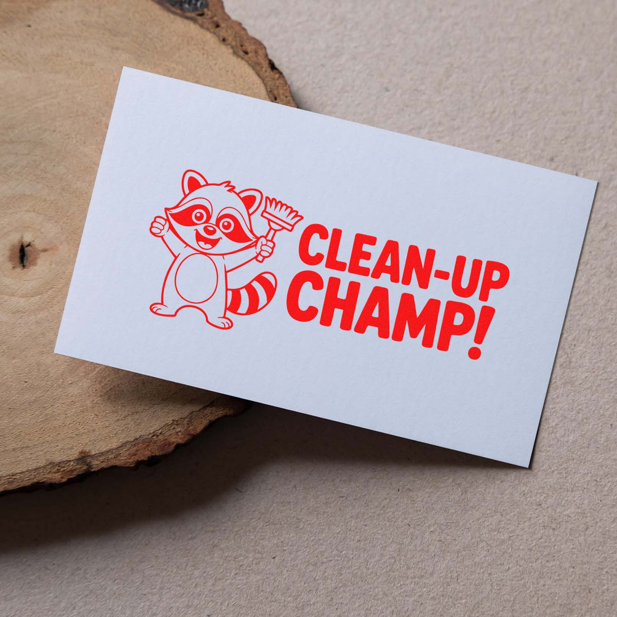 Custom rubber stamp design with raccoon and Clean-Up Champ! text on white card.
