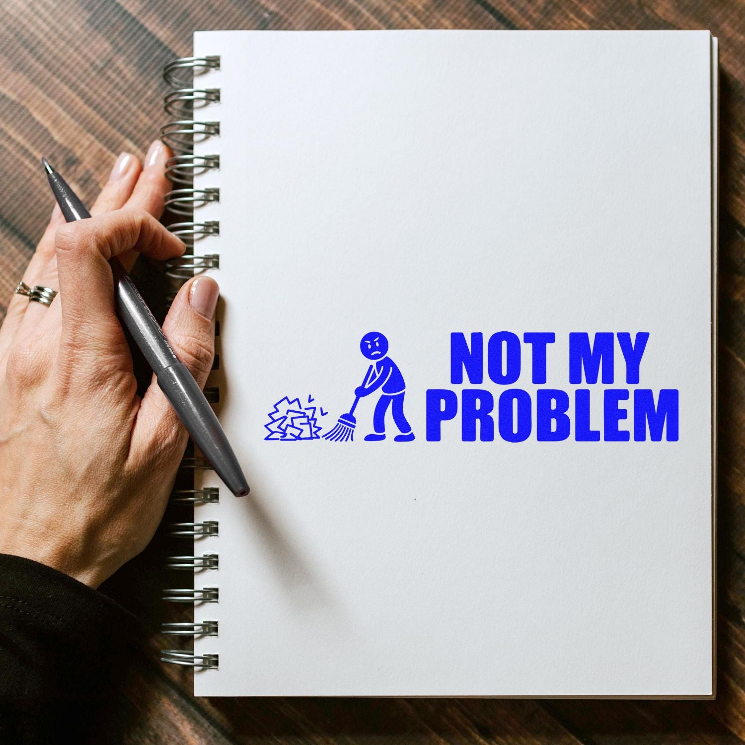 Not My Problem rubber stamp design on notebook, a funny office stamp for paperwork, planners, and sarcastic self-inking use.