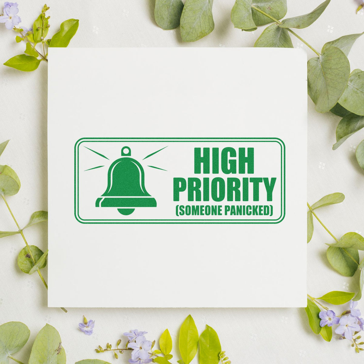 Green high priority rubber stamp design with bell icon and Someone Panicked text for office, planner, and craft use.