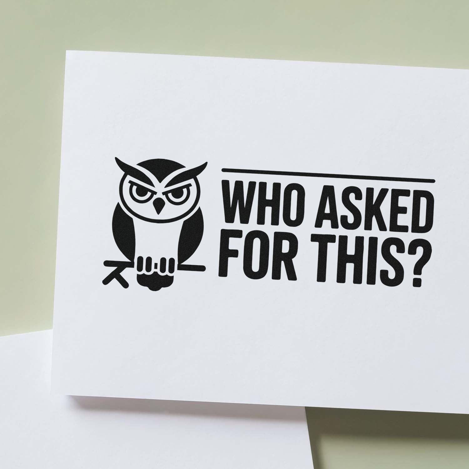 Funny custom rubber stamp design with owl graphic and bold Who Asked for This? quote on white paper.