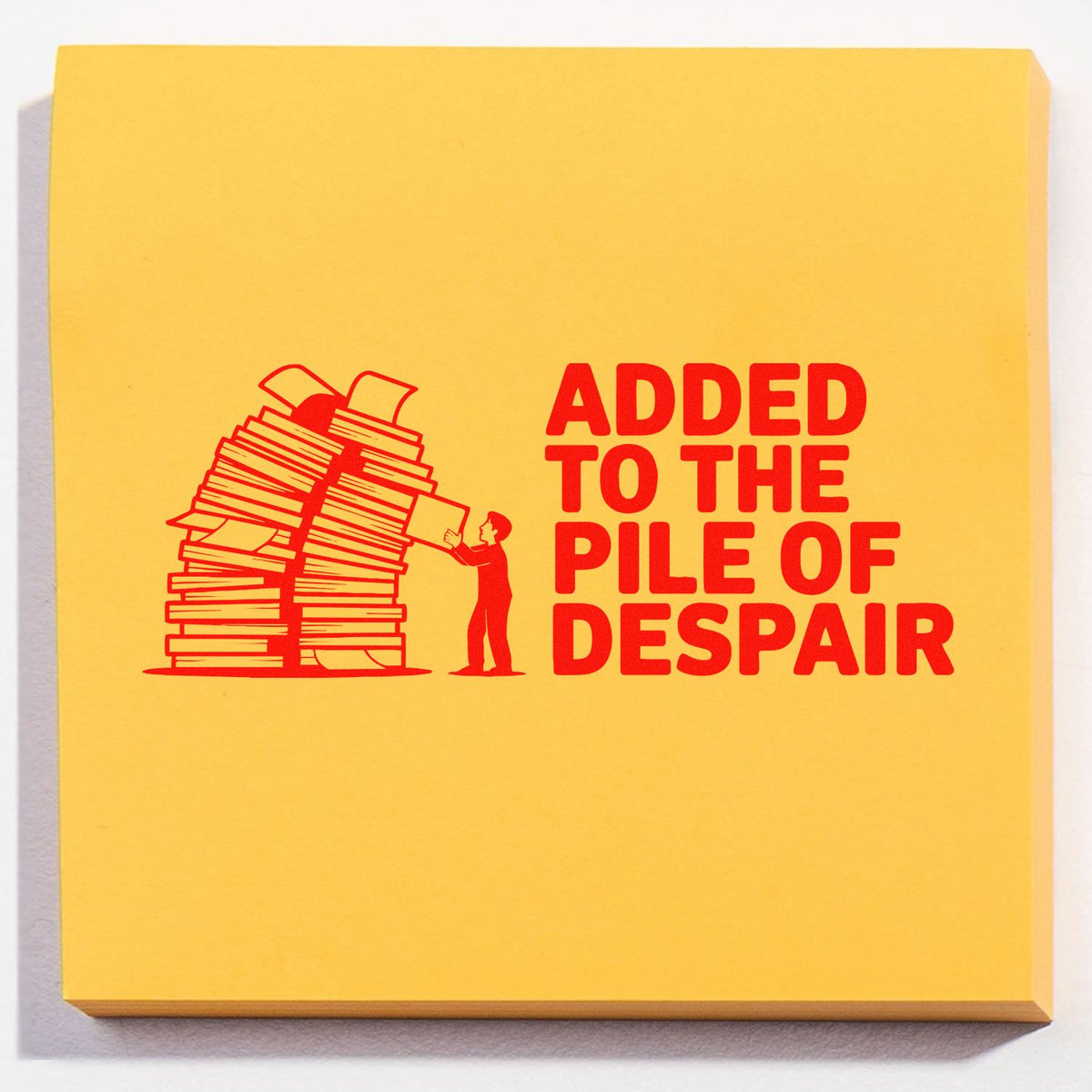Office rubber stamp design reading Added to the Pile of Despair with a person beside a towering stack of paperwork.