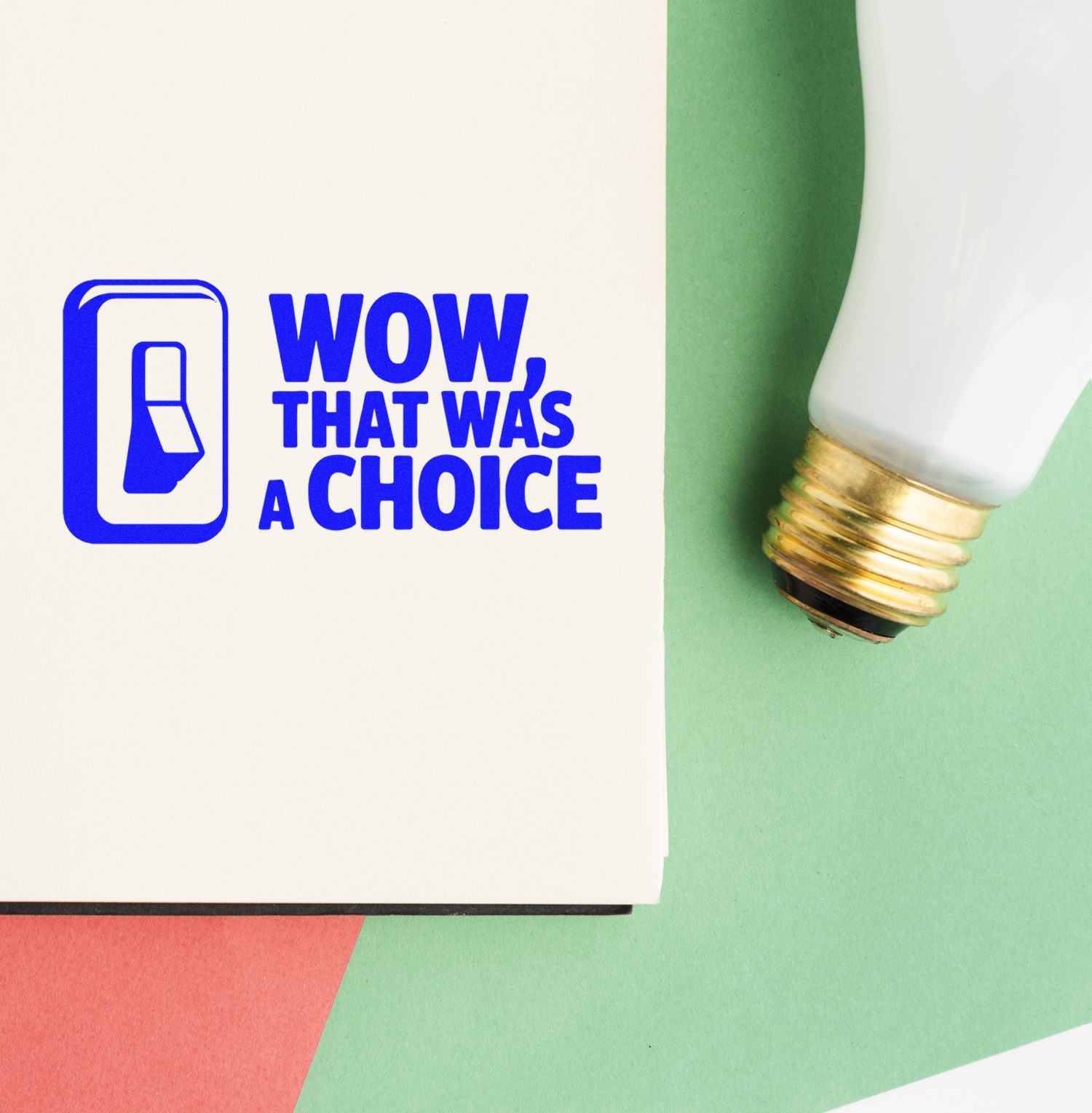 Custom rubber stamp imprint reading Wow, That Was a Choice with a light bulb icon on paper beside the stamp handle.