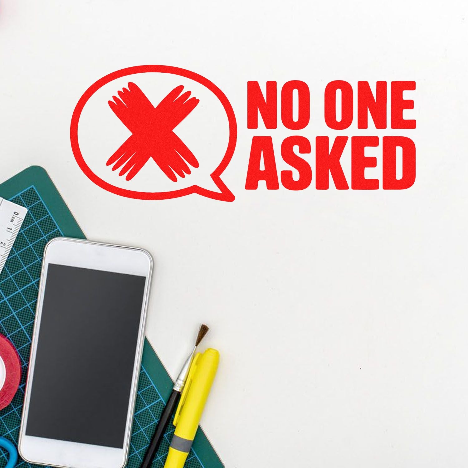 No one asked rubber stamp design with red speech bubble icon and crossed hands, shown on a craft desk with tools.