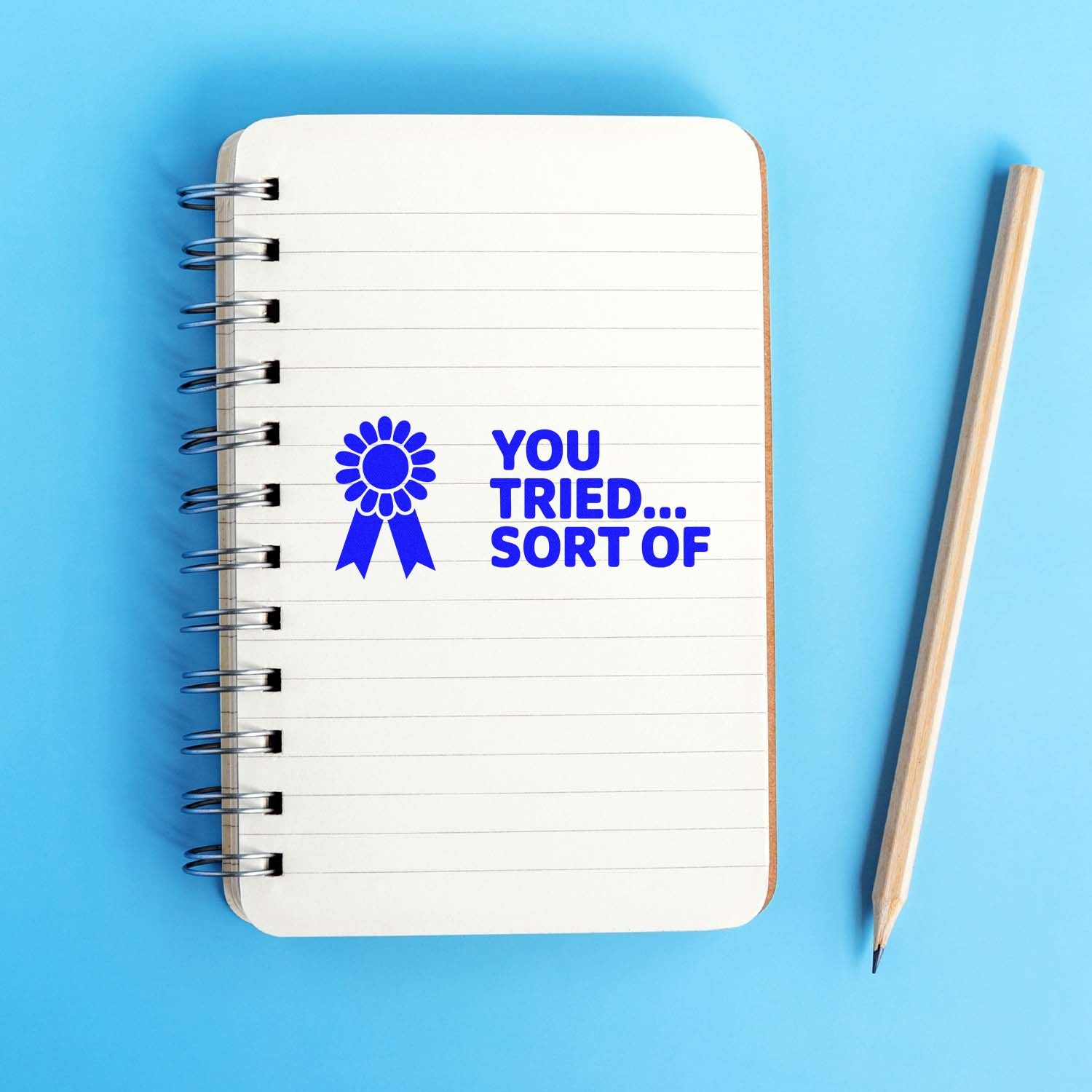 Blue rubber stamp design reading You Tried... Sort Of for playful teacher feedback on notebooks and papers.