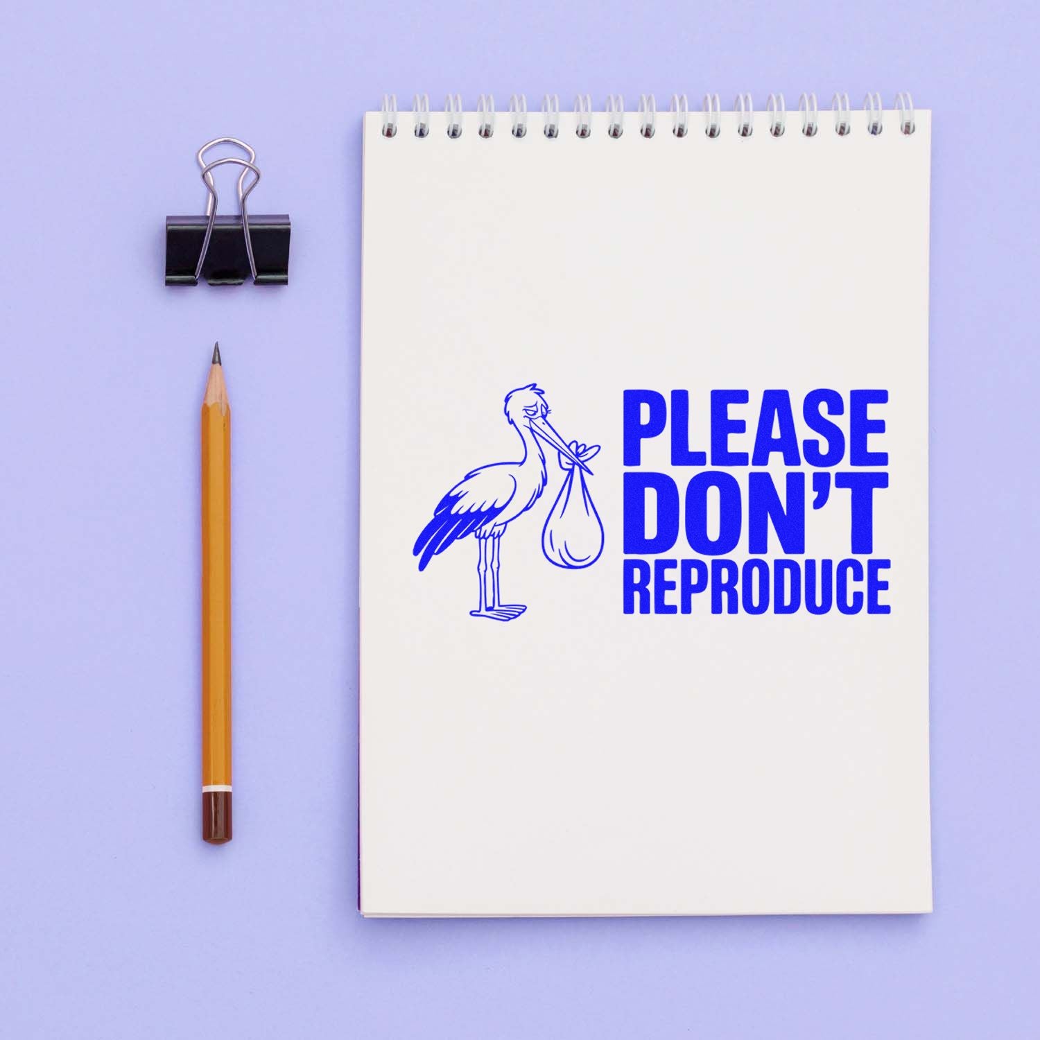 Funny rubber stamp impression with stork and Please Dont Reproduce message on a notebook page.