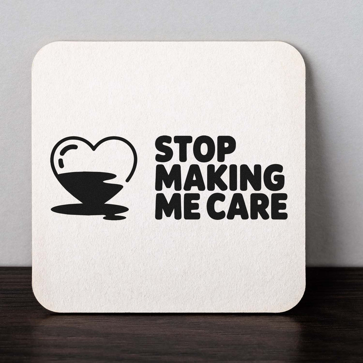 Custom rubber stamp design with heart icon and bold Stop Making Me Care text for sarcastic crafts, cards, and stationery.