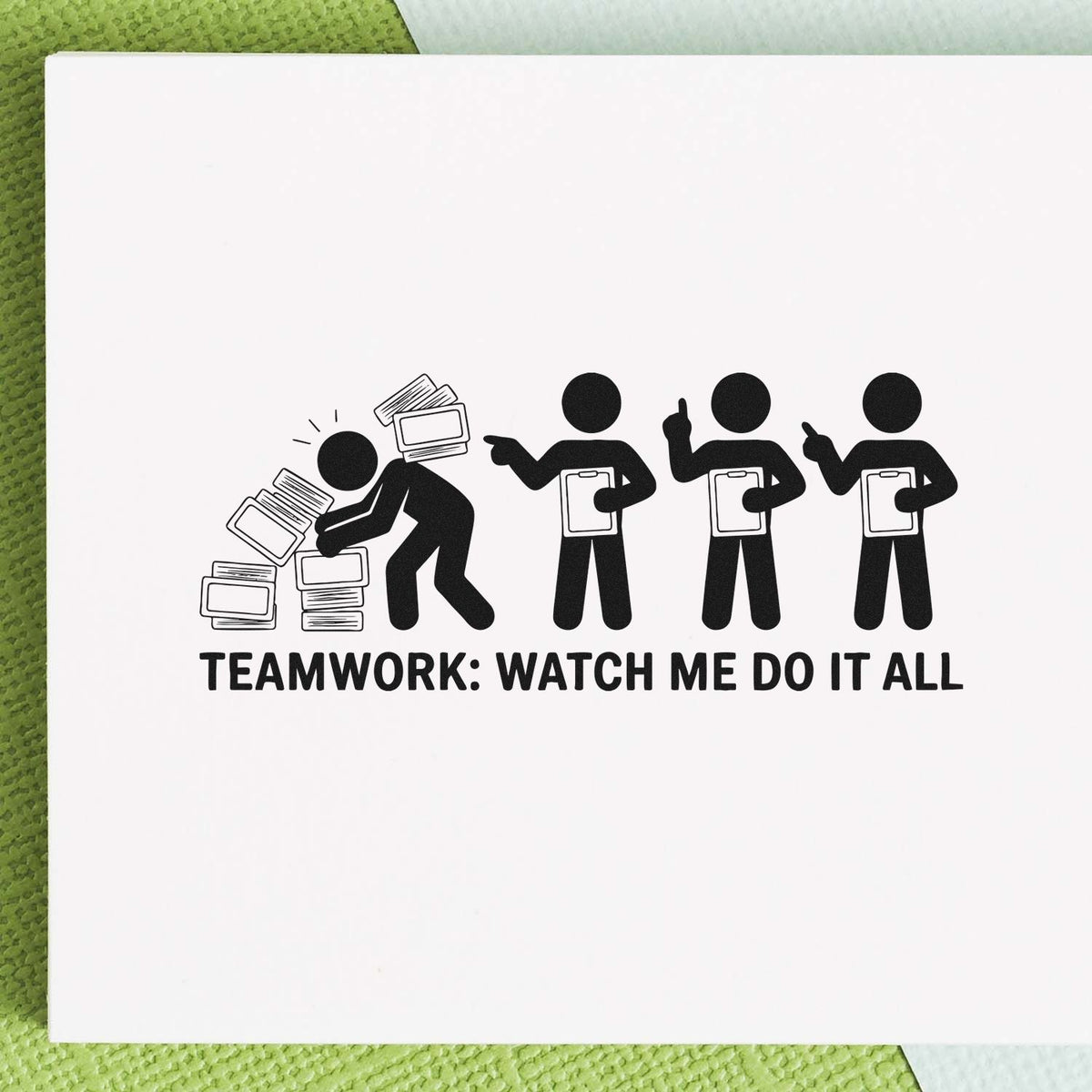 Custom rubber stamp design reading Teamwork: Watch Me Do It All with office figures and paperwork for workplace humor.