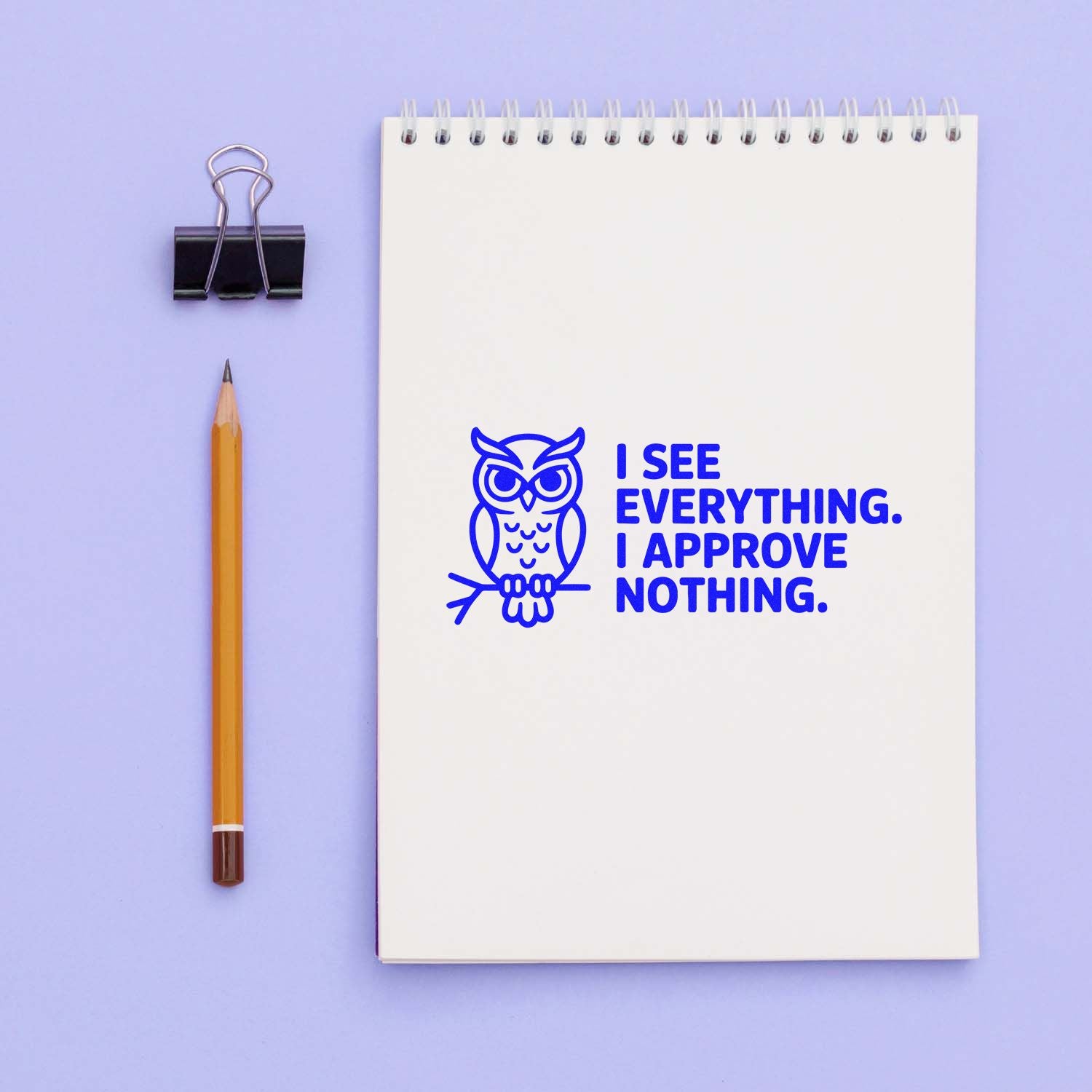 Owl rubber stamp impression with I see everything. I approve nothing. on a spiral notebook, ideal for office supplies and gifts
