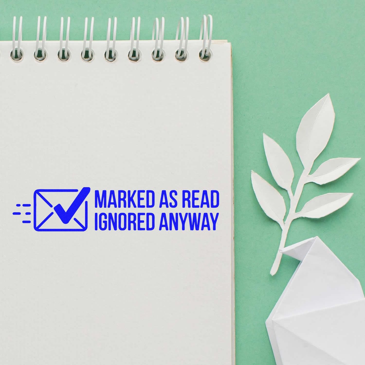 Custom rubber stamp design reading Marked as Read, Ignored Anyway on a notebook page