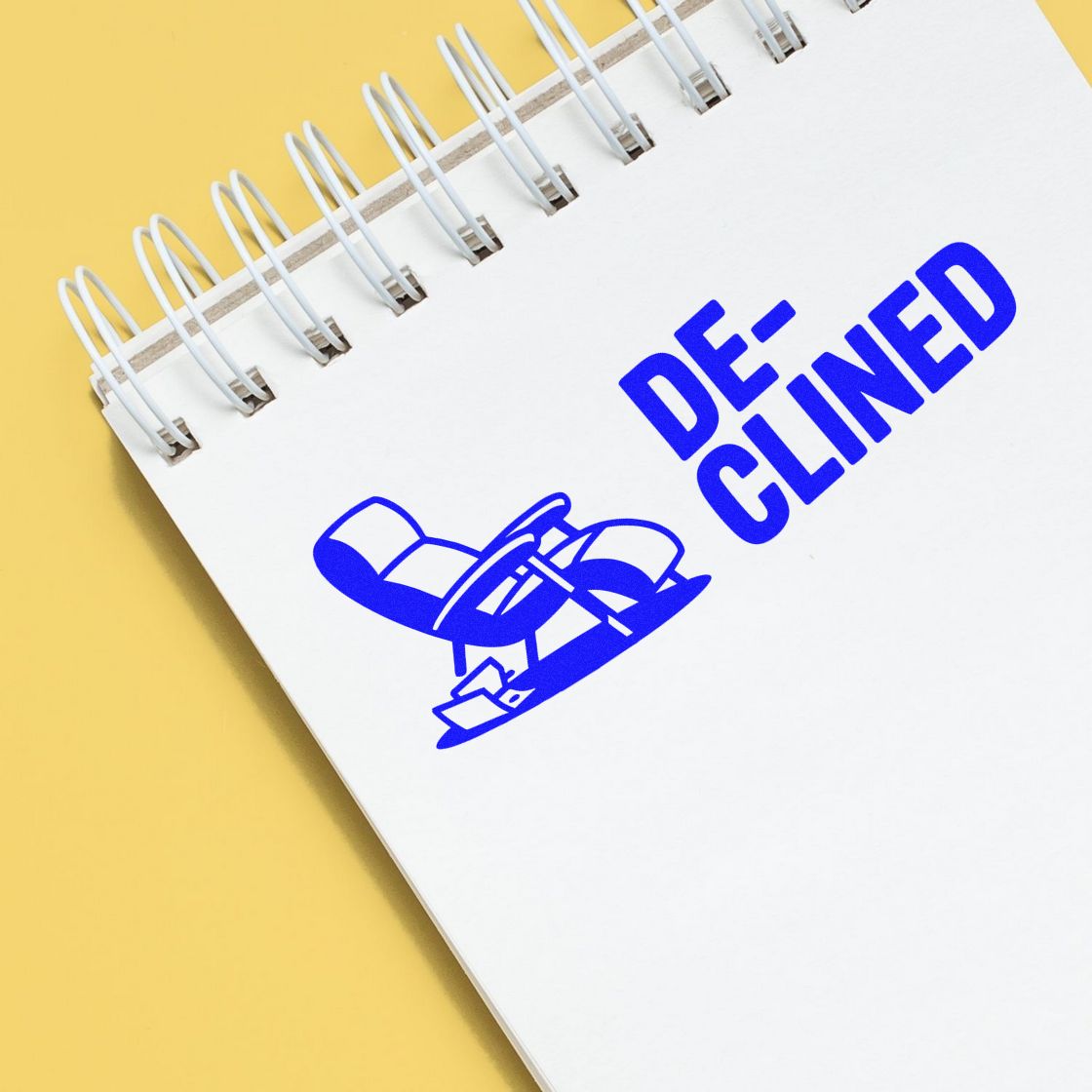 Blue declined rubber stamp on notebook page, ideal for marking rejected documents and approval status.