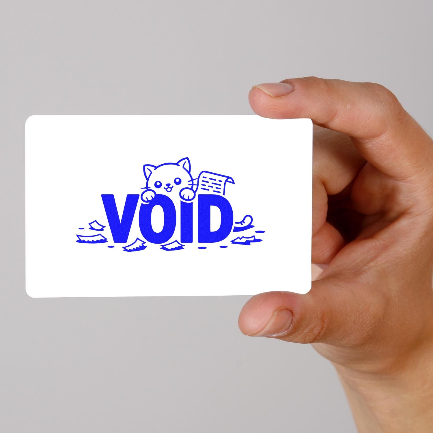 Hand holding custom VOID rubber stamp design with cat illustration, ideal for document cancellation and packaging use.