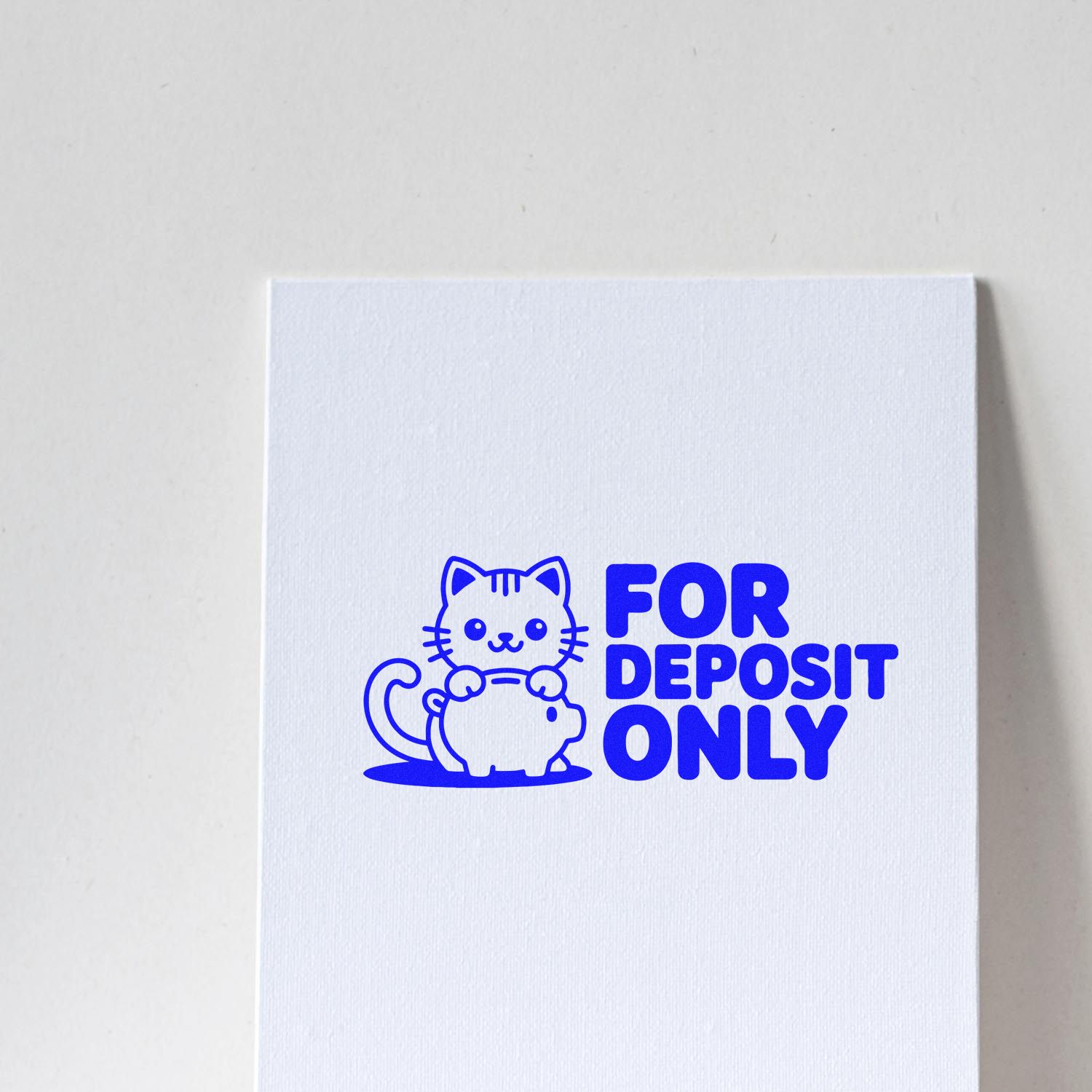 Blue For Deposit Only rubber stamp with cat and piggy bank design, ideal for bank check endorsement and business deposits.
