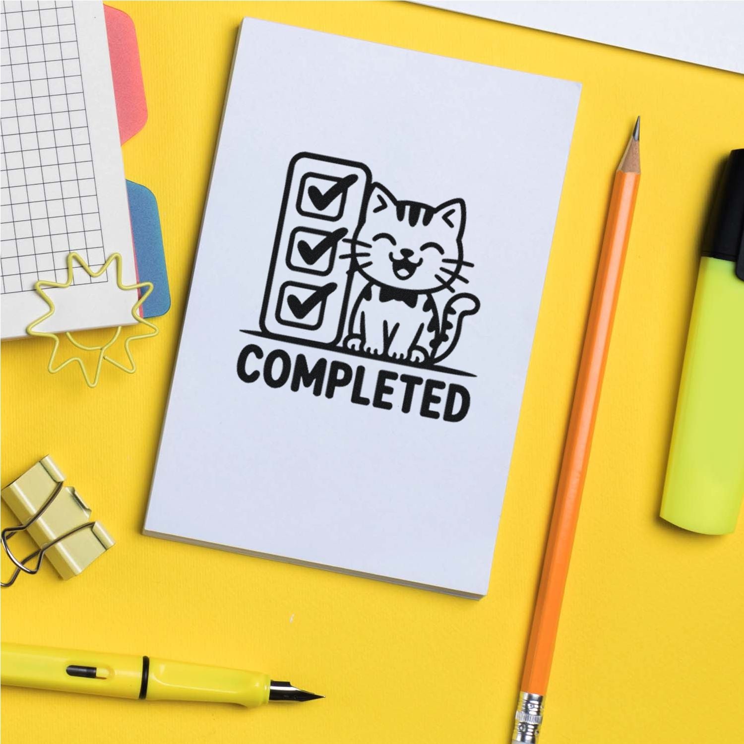 Completed cat checklist rubber stamp design on notebook, perfect for planners, teacher stamps, and office organization.