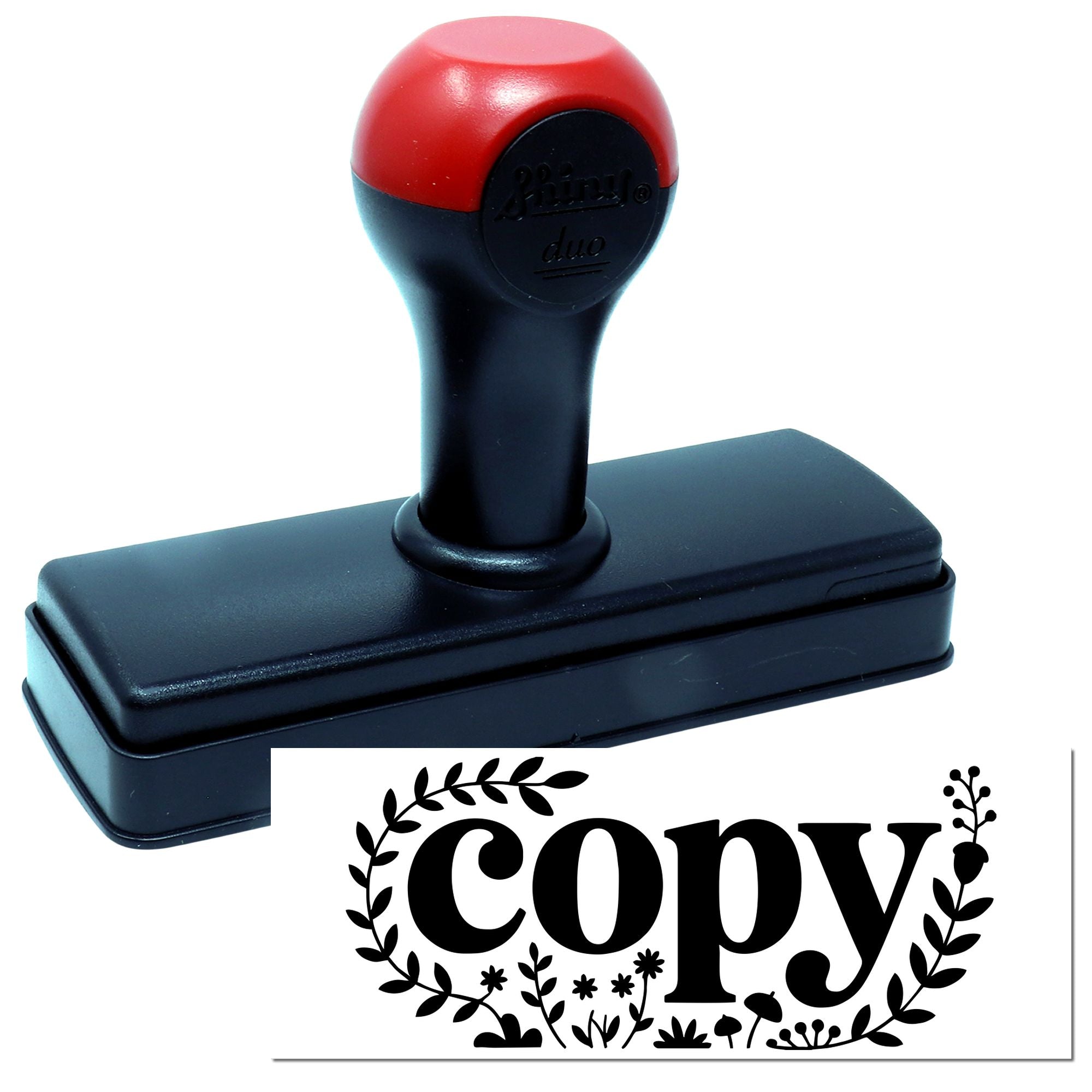 Self-inking copy rubber stamp with floral border, used for office document marking and duplicate labels.
