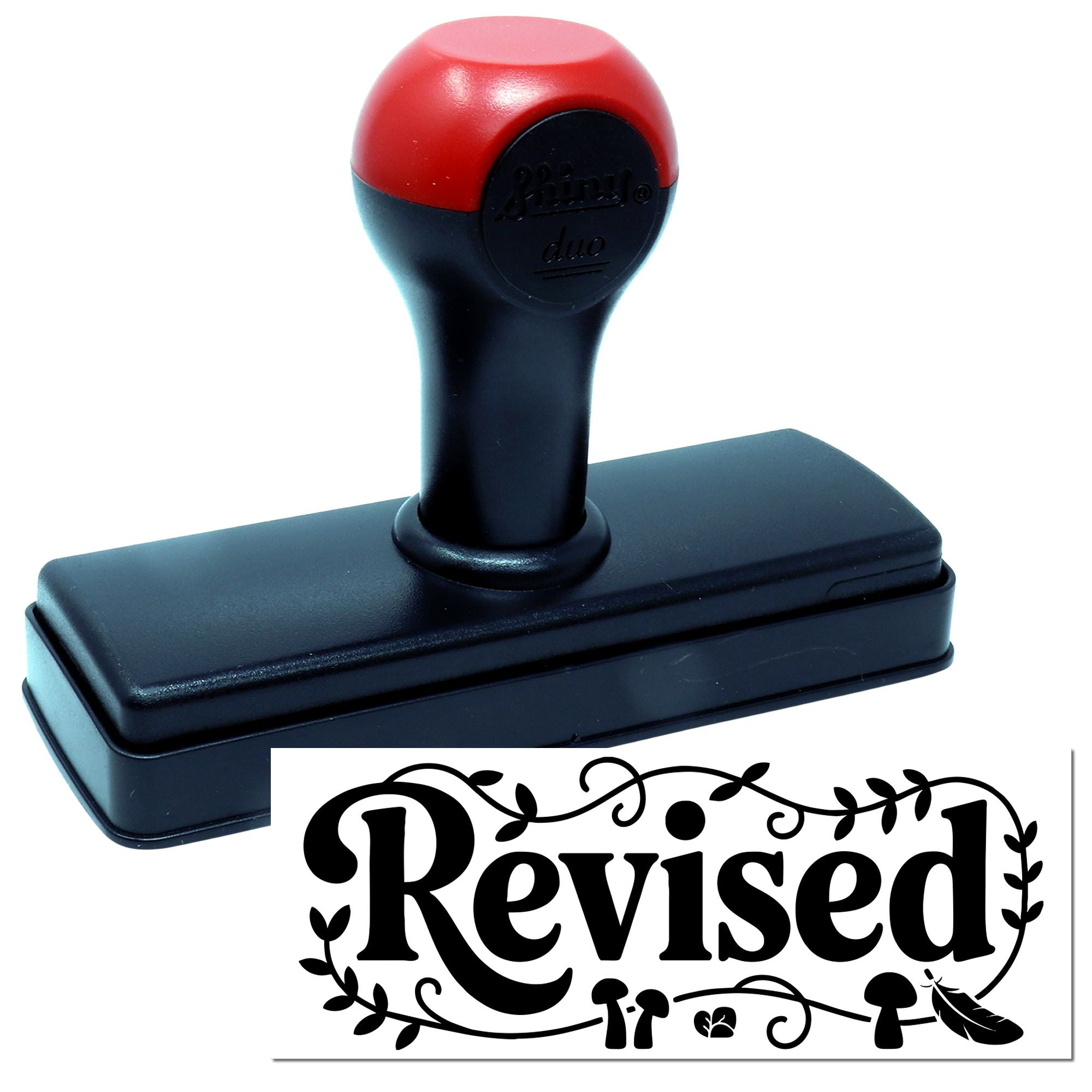 Self-inking rubber stamp with red handle and Revised imprint for office document review and approval.
