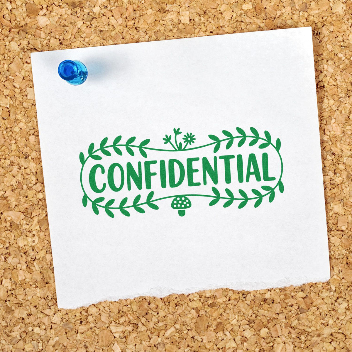 Green confidential rubber stamp imprint with floral border on pinned white paper for office document security and labeling.