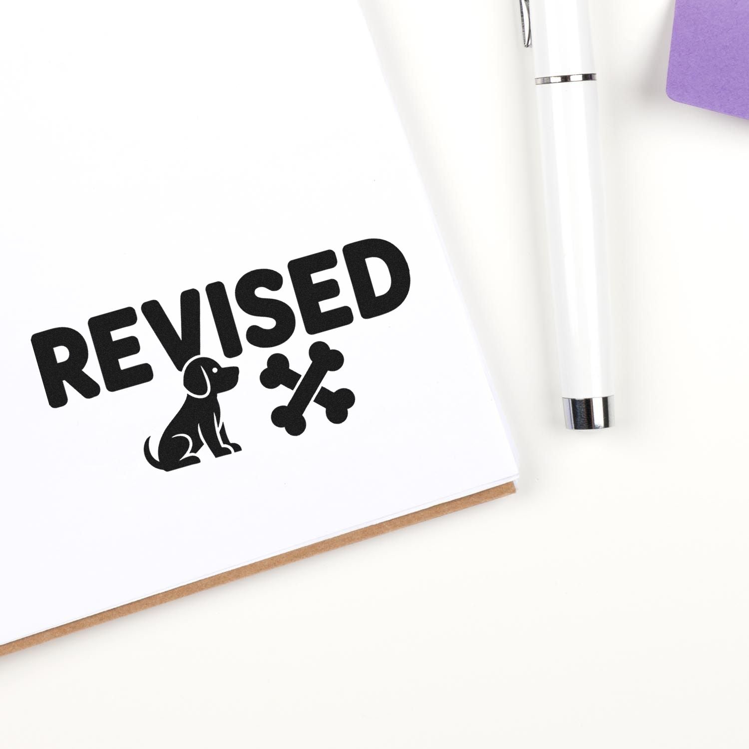 Revised rubber stamp on document with dog and bone icon, marking pet-related paperwork updates.