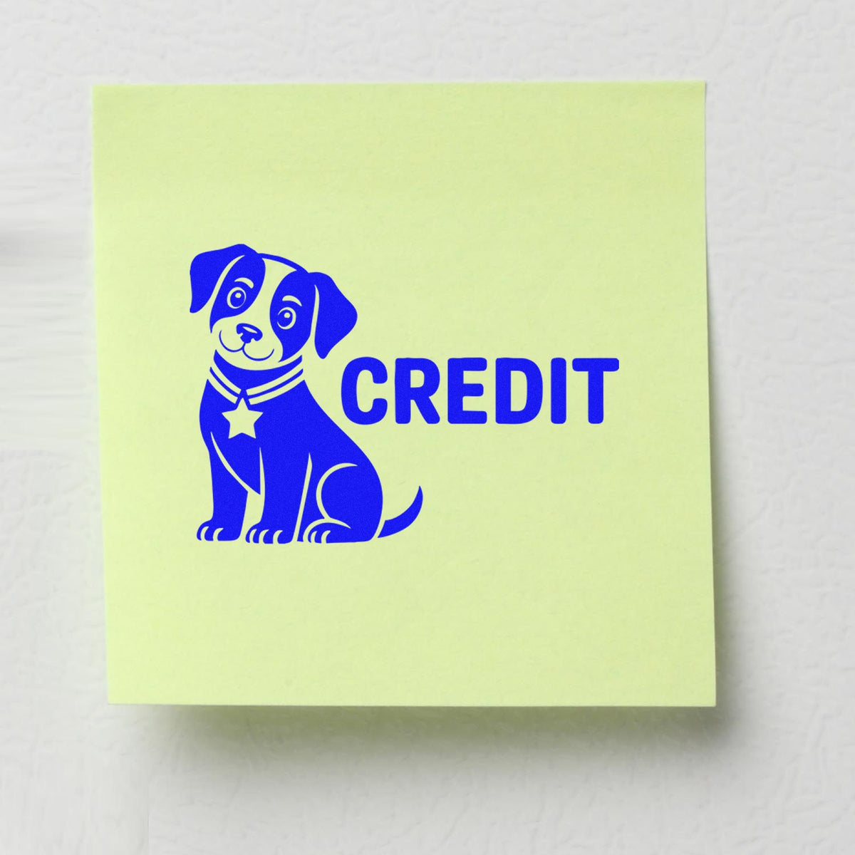 Blue CREDIT rubber stamp with dog icon on sticky note for accounting, billing, and accounts receivable approval.