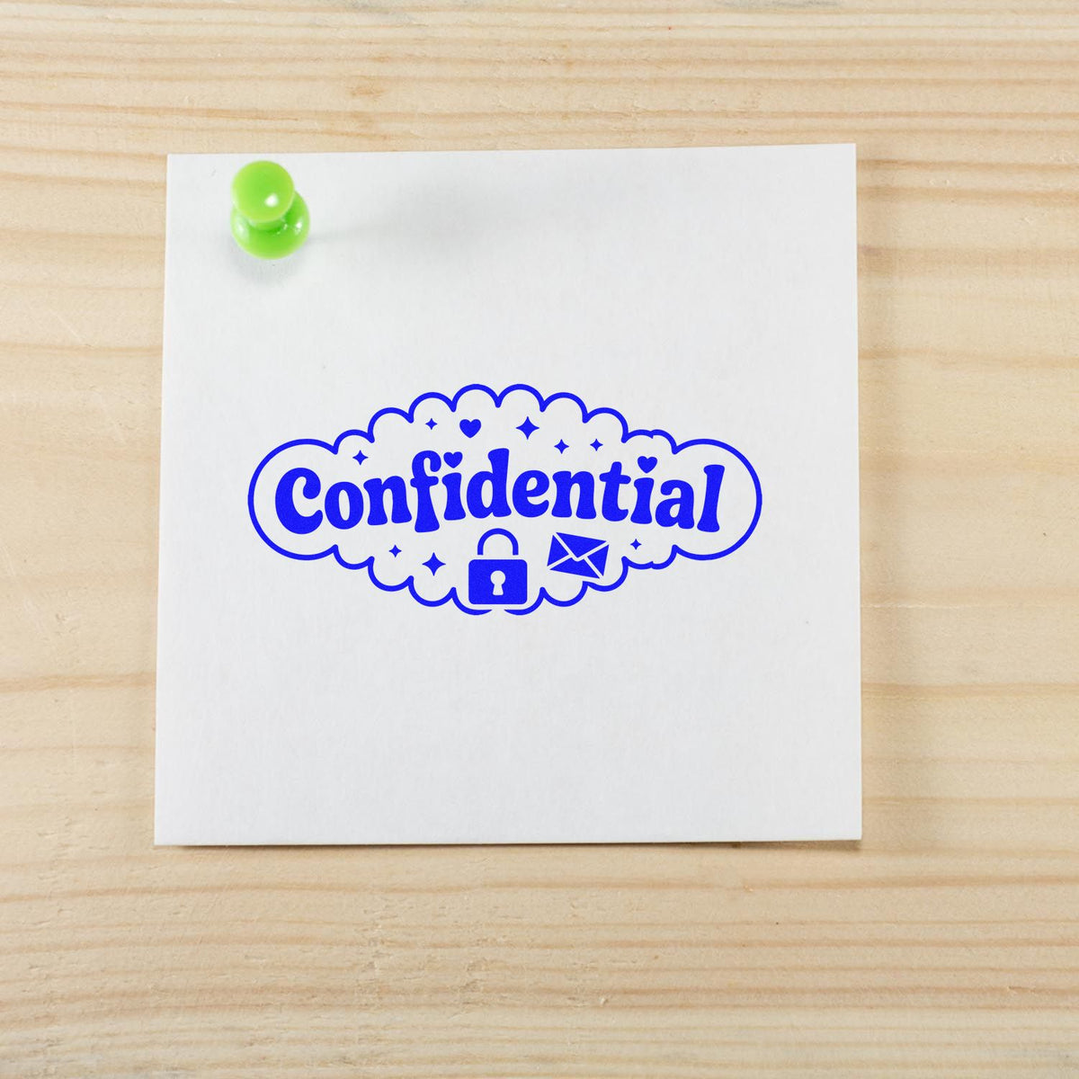 Confidential rubber stamp with lock and envelope icon on pinned note, used to mark secure documents and mail.